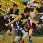 Photo by Rashah McChesney/Peninsula Clarion Nikolaevsk's Neil Gordeev passes after snatching a rebound during a game against Angoon for the March Madness Small School basketball tournament on Monday Mach 16, 2015 in Anchorage, Alaska.