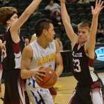Photo by Rashah McChesney/Peninsula Clarion  Elim's Wyman Anasogak looks for an opening to pass during a game against Nikolaevsk on Tuesday Mach 17, 2015 during the 2015 March Madness small schools basketball tournament in Anchorage, Alaska.