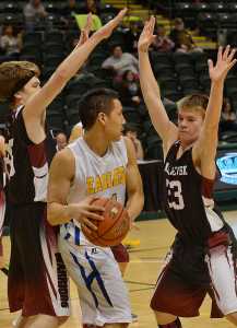 Photo by Rashah McChesney/Peninsula Clarion  Elim's Wyman Anasogak looks for an opening to pass during a game against Nikolaevsk on Tuesday Mach 17, 2015 during the 2015 March Madness small schools basketball tournament in Anchorage, Alaska.