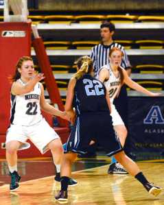 Photo by Rashah McChesney/Peninsula Clarion Nikiski's Avery Kornstad blocks Valdez's Veronica Hursh during their March Madness large school state tournament game on March 19, 2015. Valdez won 47-33.