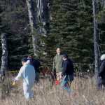 Photo by Rashah McChesney/Peninsula Clarion  A Kenai police officer walks down a trail leading to a temporary camp where police and Federal Bureau of Investigations personnel  on Sunday March 22, 2015 are working to identify remains of what Kenai Police believe to be a family who have been missing for nearly 10 months from their Kenai, Alaska home. While most of the land in the immediate area is state or federally owned, the place where police and the Federal Bureau of Investigation investigators is focusing their efforts, is a privately owned parcel.
