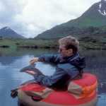 A fly-fisherman shows off a grayling caught from a float tube. (Photo courtesy Dave Atcheson)