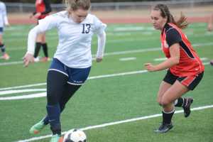 Photo by Kelly Sullivan/ Peninsula Clarion Soldotna High School's Miranda Wolfe gets rid of the ball before Kenai High School's Heidi Perkins steal it Friday, April 17, 2015, at Kenai Central High School in Kenai, Alaska.