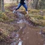 Photo by Rashah McChesney/Peninsula Clarion Patty Moran leaps from one side of a trail to the other during the Choose Your Weapon race on the Tsalteshi Trails Saturday April 18, 2015 in Soldotna, Alaska.