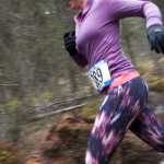 Photo by Rashah McChesney/Peninsula Clarion Aurora Agle (CHECK THIS!!) jumps over a muddy spot during the Choose Your Weapon race on the Tsalteshi Trails Saturday April 18, 2015 in Soldotna, Alaska.