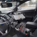 Ben Boettger/Peninsula Clarion The interior of an unredesigned Kenai police car, with a fusebox contained in the center console and a bulky swing-arm for mounting a laptop computer, photographed on Friday, April 17 at the Kenai Police Station.