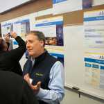 Photo by Rashah McChesney/Peninsula Clarion Michael Nelson, socioeconomic lead for the Alaska LNG project, talks to a group of community members during an open house on Thursday April 23, 2015 at the Nikiski Community Recreation Center in Nikiski, Alaska. More than 150 people attended the project meeting to learn about changes and the feasibility studies planned for 2015.