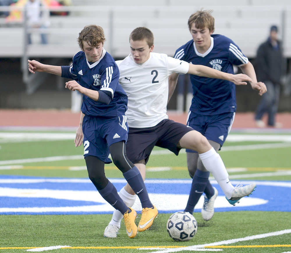 Photo by Rashah McChesney/Peninsula Clarion (left) Soldotna high school's Thomas Flores, Eagle River's Seth Hard and Soldotna's Dylan Kuntz tangle during their game on Friday April 24, 2015 in Soldotna, Alaska.