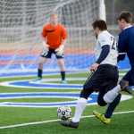 Photo by Rashah McChesney/Peninsula Clarion  Eagle River goalie Chris Jensen watches as Soldotna's Tyler Fenton and Eagle River's Jeff Hartmann tangle near the goal on Friday April 24, 2015 in Soldotna, Alaska.