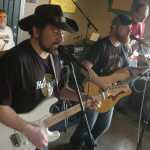 Ben Boettger/Peninsula Clarion Lee Gattenby (left) plays an electric guitar solo alongside vocalist and rhythm guitarist Eric Doucet during a show on Sunday, April 25 at Coffee Roasters in Kenai.