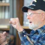 Photo by Kelly Sullivan/ Peninsula Clarion Raymon Machen-Gray listens to a story from Korean War veteran Jack Dean Thursday, April 30, 2015, at Kenai Central High School in Kenai, Alaska.