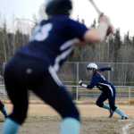 Ben Boettger/Peninsula Clarion Soldotna girls softball player Jazi Larrow prepares to steal second from Chugiak first baseman Alise Arnold, with Renee Hinz at bat during a game on Friday May 1 in Soldotna.