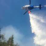 Division of Forestry A Palmer-based air tanker dumps fire-retardant chemicals near a five-acre fire on Monday, May 4, between Anchor Point and Nikolaevsk.