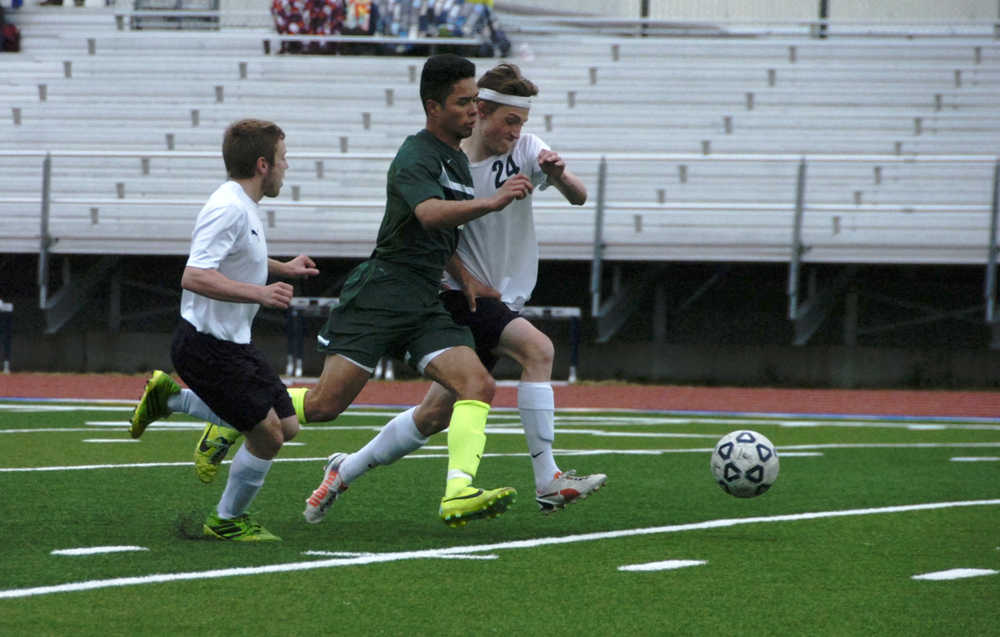 From left to right: Soldotna Boy's Varsity soccer player Austin Craig, Colony's Alex Valdez, and Soldotna's Ben Godfrey chase the ball at match on Friday, May 8 at Soldotna High School.