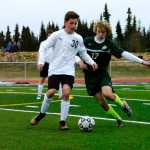 Ben Boettger/Peninsula Clarion Soldotna Varsity Boy's soccer player Ethan Bot and Colony's Jake Forstner fight for the ball at a match on Friday, May 8 at Soldotna High School.