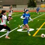 Ben Boettger/Peninsula Clarion Kenai Central High School Girl's Varsity soccer player Cassi Holmes and Palmer's Kiley Fish chase the ball at a match on Friday, May 8 at Kenai Central High School.
