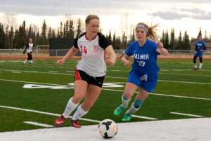 Ben Boettger/Peninsula Clarion Kenai Central High School Girl's Varsity soccer player Hannah Drury (left) fights for the ball with Palmer's Caile Dosser at match on Friday, May 8 at Kenai Central High School.