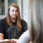 Photo by Rashah McChesney/Peninsula Clarion Johnathan Rine, dungeon master for a Dungeons & Dragons group, eyes a newer player during a meeting on April 22, 2015 at the Soldotna Public Library.  The group will be hosting its first all-day D&D marathon on Saturday May 16 from 10 a.m. to 5:30 p.m. in the community room at the library.