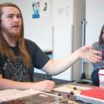 Photo by Rashah McChesney/Peninsula Clarion Johnathan Rine, dungeon master for a group who plays the fantasy role-playing game Dungeons & Dragons, explains the subtleties of character building as Soldotna Public Library Youth Service Director KJ Hillgren laughs in the background on April 22, 2015 at the library. Rine and several others in his group will host a D&D marathon day, open to the public, on Saturday from 10 a.m. to 5:30 p.m.