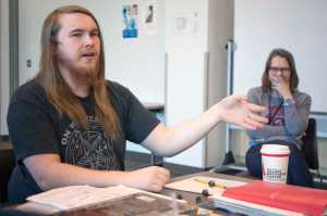 Photo by Rashah McChesney/Peninsula Clarion Johnathan Rine, dungeon master for a group who plays the fantasy role-playing game Dungeons & Dragons, explains the subtleties of character building as Soldotna Public Library Youth Service Director KJ Hillgren laughs in the background on April 22, 2015 at the library. Rine and several others in his group will host a D&D marathon day, open to the public, on Saturday from 10 a.m. to 5:30 p.m.