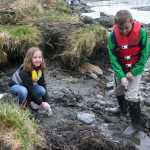 Kids collecting trash help Kenai River Spring Cleanup