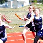 Ben Boettger/Peninsula Clarion Soldotna track team members Elizabeth Davis and McKayla Hensley hand off to Katelyn Earl and Myah Smith, respectively, during a relay Saturday at the Kenai Peninsula Borough track meet at Soldotna High School.