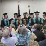 Photo by Will Morrow/Peninsula Clarion Members of the River City Academy Class of 2015 pose for photos after turning their tassels during a commencement ceremony Monday, May 18, 2015 at the Soldotna Regional Sports Complex.