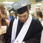 Photo by Kelly Sullivan/ Peninsula Clarion School secretary Margie Warner says a tearful goodbye to graduating senior Taylor Andeway following commencement Wednesday, May 21, 2015, in the Nikiski Middle-High School commons area in Nikiski, Alaska.
