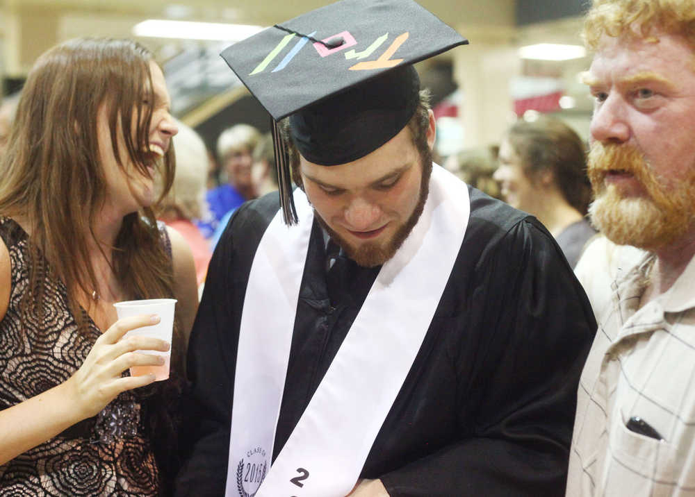 Photo by Kelly Sullivan/ Peninsula Clarion School secretary Margie Warner says a tearful goodbye to graduating senior Taylor Andeway following commencement Wednesday, May 21, 2015, in the Nikiski Middle-High School commons area in Nikiski, Alaska.