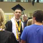 Photo by Kelly Sullivan/ Peninsula Clarion Senior 2015 Class President Taylor Jensen gets a hug from a friend following commencement Wednesday, May 21, 2015, in the Nikiski Middle-High School commons area in Nikiski, Alaska.