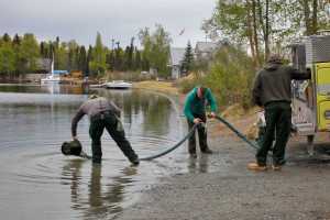 Photo by Rashah McChesney/Peninsula Clarion  Firefighters from the Soldotna office of the Alaska Division of Forestry draw water out of Sport Lake during a brief training on Tuesday May 19, 2015 in Soldotna, Alaska. Firefighters said conditions are hot and dry enough to merit concern and an elevated level of fire danger on the Kenai Peninsula.