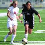 Wasilla sophomore Jodie Richey tries to race past Nikiski sophomore Brianna Vollertsen during an 8-0 win over the Bulldogs in the Northern Lights Conference quarterfinals May 21 at Colony High School in Palmer.