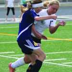 Colony junior Ripley Wakaliuk works to keep the ball away from Homer freshman Aspen Daigle during a 4-0 win over the Mariners in the Northern Lights Conference quarterfinals May 21 at Colony High School in Palmer.