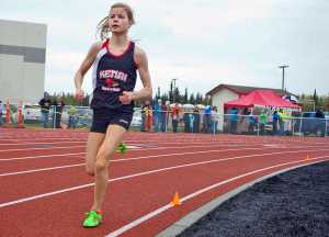 Photo by Rashah McChesney/Peninsula Clarion  Allie Ostrander stays well ahead of the pack during the girls 1600 meter race at the Region III championships on Saturday May 23, 2015 in Kenai, Alaska. Ostrander finished with a time of 4:48.32, the fastest so far this year in Alaska.
