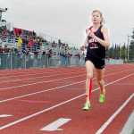 Photo by Rashah McChesney/Peninsula Clarion  Allie Ostrander stays well ahead of the pack during the girls 1600 meter race at the Region III championships on Saturday May 23, 2015 in Kenai, Alaska. Ostrander finished with a time of 4:48.32, the fastest so far this year in Alaska.