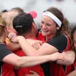 A group of Kenai Kardinals hug head coach Dan Verkuilen after the Kards beat Soldotna 3-2 in overtime of the Northern Lights Conference girls' title match May 23 at Palmer High School.