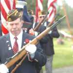 Photo by Kelly Sullivan/ Peninsula Clarion Members of the Kenai  American Legion Post 20, Soldotna AMVETS Post 4 and Soldotna Veterans of Foreign Wars Post 10046 make up the Color Guard Monday, May 25, 2015 at the Kenai Cemetery in Kenai, Alaska.