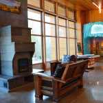 The Center's lobby overlooks the surrounding boreal forest through floor to ceiling windows. The masonry heater's hearth is a welcome place to sit and relax all year-round. (Photo courtesy Kenai National Wildlife Refuge)