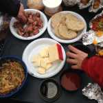 ADVANCE FOR USE MONDAY, MAY 25 -  In this photo taken May 9, 2015, a smorgasbord of dishes are displayed on a table during a campsite cooking competition at the Granite Tors campground near Fairbanks, Alaska.  Everything tastes better on a camping trip, but that doesn't mean camp food can't be improved on. (Sam Friedman/The Fairbanks Daily News-Miner via AP) MANDATORY CREDIT