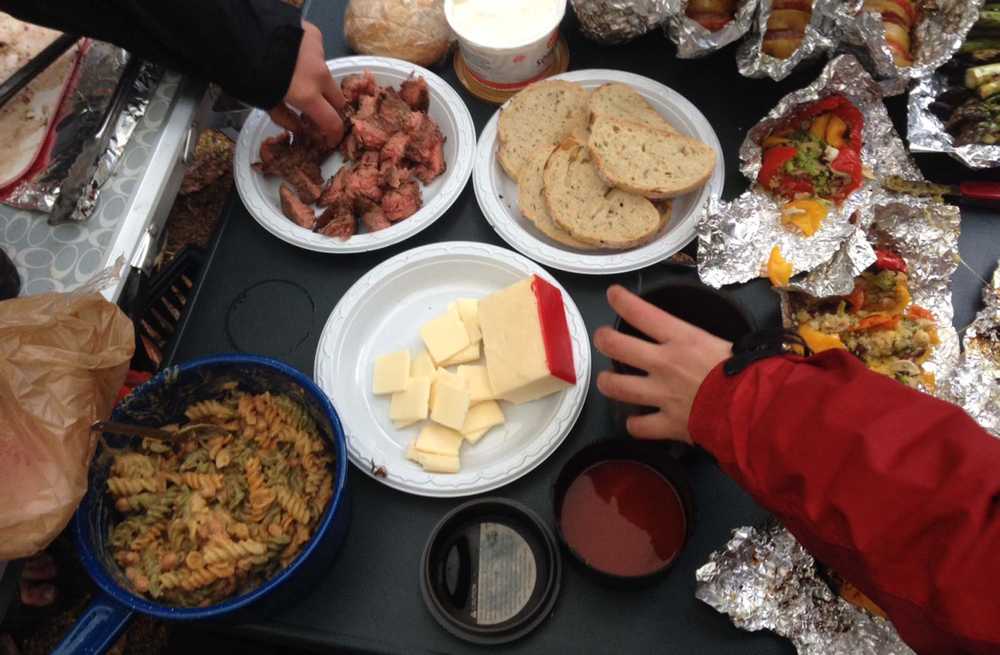 ADVANCE FOR USE MONDAY, MAY 25 -  In this photo taken May 9, 2015, a smorgasbord of dishes are displayed on a table during a campsite cooking competition at the Granite Tors campground near Fairbanks, Alaska.  Everything tastes better on a camping trip, but that doesn't mean camp food can't be improved on. (Sam Friedman/The Fairbanks Daily News-Miner via AP) MANDATORY CREDIT