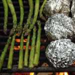 ADVANCE FOR USE MONDAY, MAY 25 -  In this photo taken May 9, 2015, asparagus and potatoes cook on a grill during a camp cooking competition at the Granite Tors campground near Fairbanks, Alaska.  Everything tastes better on a camping trip, but that doesn't mean camp food can't be improved on. (Sam Friedman/The Fairbanks Daily News-Miner via AP) MANDATORY CREDIT