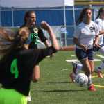 Soldotna junior Reagan Schoessler (99) competes for the ball with Service junior Madasin Jennings (2) in the first half of Thursday's girls state quarterfinal match at Bartlett High School in Anchorage. The Stars lost 2-0 to the Cougars.