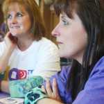 Photo by Kelly Sullivan/ Peninsula Clarion Linda Ruffridge, a survivor of Malignant Melinoma, listens to a fellow survivor during the 2015 Relay For Life survivor's dinner Friday, May 29, 2015, at the Soldotna Regional Sports Complex in Soldotna, Alaska.