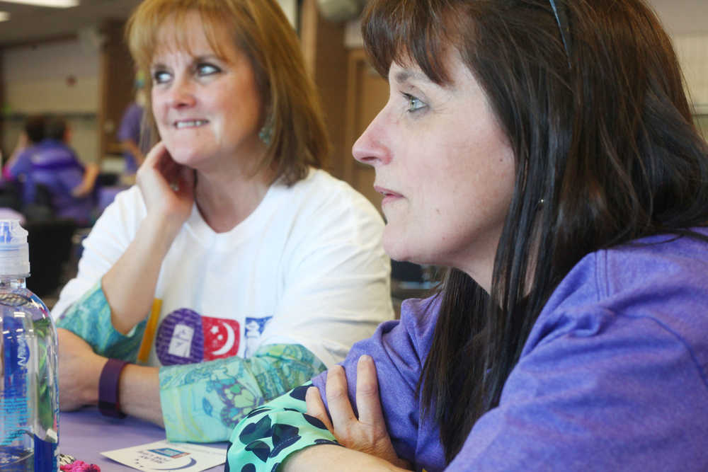 Photo by Kelly Sullivan/ Peninsula Clarion Linda Ruffridge, a survivor of Malignant Melinoma, listens to a fellow survivor during the 2015 Relay For Life survivor's dinner Friday, May 29, 2015, at the Soldotna Regional Sports Complex in Soldotna, Alaska.