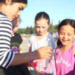 Photo by Kelly Sullivan/ Peninsula Clarion Maddy Triana, Sienna Luataret and Emma Glassmarker load tiny squirt guns during the 2015 Relay For Life Friday, May 29, 2015, at the Soldotna Regional Sports Complex in Soldotna, Alaska.