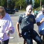 Photo by Kelly Sullivan/ Peninsula Clarion Alyson Stogsdill, a breast cancer survivor and Kenai Legislative Information Officer, hits Sen. Peter Micciche, R-Soldotna, with a pie during the 2015 Relay For Life Friday, May 29, 2015, at the Soldotna Regional Sports Complex in Soldotna, Alaska.