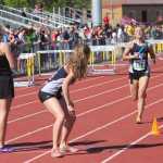 Soldotna senior Sadie Fox (714) finishes up her leg of the girls 3,200-meter relay before handing the baton off to senior teammate Dani McCormick, Saturday at the Alaska state high school track and field championships in Anchorage. The Stars claimed victory and set a new state record in the race.