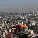 In this picture taken Friday, May 22, 2015, Iranian Hamed Heidari lies across a slackline anchored between two rocks during practice in the mountains overlooking Tehran, Iran.  (AP Photo/Vahid Salemi)