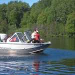 Kenai National Wildlife Refuge staff apply pelleted fluridone to kill Elodea in Beck Lake last summer.  Elodea was present at 35 of 50 sampled sites in May 2014 - these same sites now have none. (Photo courtesy Kenai National Wildlife Refuge)
