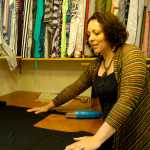 Photo by Megan Pacer/Peninsula Clarion Clothing designer Susanna Evins, of Soldotna, prepares her next garment Wednesday in her new location for Mountain Mama Originals in Soldotna.